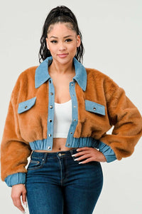 Cropped faux fur jacket with denim trim worn over a white crop top