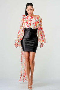 Blossom Leatherette Mini Dress," an exquisite fusion of edgy modernity and romantic florals. This dress showcases a striking contrast with its vibrant floral print from the waist up, creating an aura of a blossoming garden, while the sleek leather-like detail from the waist down adds a bold, contemporary edge