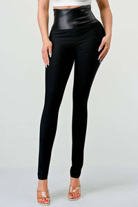 High-Waist Black Leggings with Leather Detail: Black leggings featuring a high-waisted faux leather waistband. The fitted design offers both comfort and a stylish, contemporary touch.