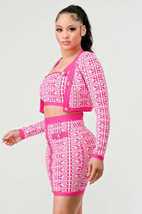 Geometric Print Two-Piece Outfit in Pink and White: A trendy two-piece outfit featuring a pink and white geometric print. The crop top has long sleeves and gold button details, paired with a high-waisted skirt with matching button embellishments.