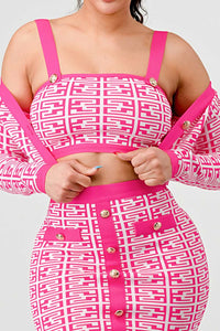 Trendy Pink and White Geometric Co-Ord Set: A trendy co-ord set featuring a pink and white geometric print. The long-sleeve crop top and high-waisted skirt both include gold button details for added style.