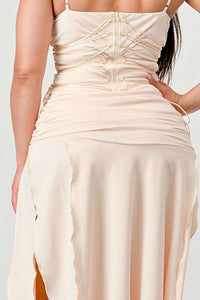 Beige ruched dress with thin straps and a thigh-high slit