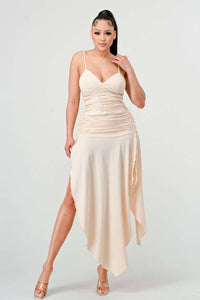 Elegant cream-colored midi dress with spaghetti straps and a ruched bodice. 