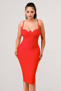 Woman wearing a red bodycon dress with spaghetti straps and sweetheart neckline