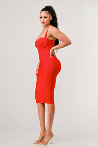 Woman in a red midi dress with a sweetheart neckline and bodycon fit