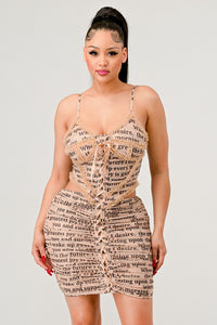 Fashion-forward newspaper print dress featuring a tie-front detail and a figure-flattering silhouette