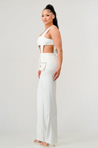 The Modern Elegance Two-Piece Set in white, combining a bold crop top and sculpting trousers with lace-up accents.