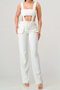 Sophisticated white two-piece set featuring a square-neck crop top with cut-out details and high-waisted lace-up trousers.