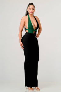 Fashionable woman in a two-tone halter neck long dress