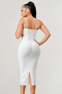 Sophisticated White Bodycon Dress with Gold Accents: This white bodycon dress features gold studded detailing on the bust, double shoulder straps, and side cut-outs. The fitted design emphasizes a sleek and elegant look.