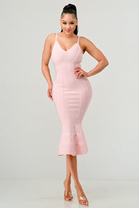 Elegant blush pink midi dress with contouring lines and ruffled flare at the bottom, showcasing a feminine silhouette.