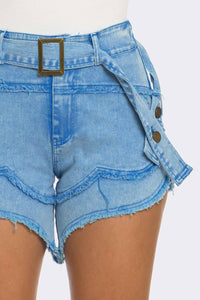 High-waisted light blue denim shorts with a frayed edge and gold buckle belt