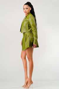 Fashion-forward faux leather two-piece set with an asymmetrical zip jacket and a playful pleated skirt in a striking olive hue.