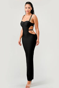 Chic Black Maxi Dress with Gold Embellished Straps: This chic black maxi dress features side cut-outs and gold embellishments on the straps. The long, form-fitting style is perfect for making a sophisticated statement.