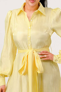 Flowy Yellow Ruffle Dress with Belt: A stylish yellow dress with a tiered ruffle skirt, long sleeves, and a collared neckline. The dress is complemented by a matching fabric belt at the waist.