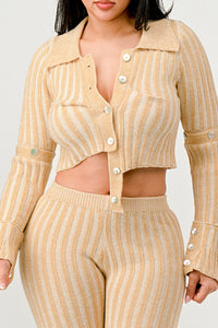 A model in a beige ribbed knit two-piece set with a cropped cardigan and high-waisted flared pants.