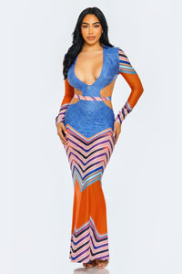 The geometric print is composed of a series of stripes and chevrons in a variety of colors, including shades of blue, orange, pink, and white. This creates an optical illusion effect that can be very flattering, as it contours the body's shape and can create a slimming effect depending on the placement of the darker stripes.