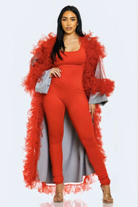 A red and blue jumpsuit ensemble featuring sheer azure sleeves with red feather trim for a bold fashion statement.